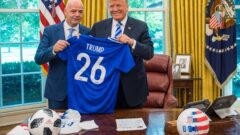 Donald Trump holds up a World Cup jersey. IMAGO
