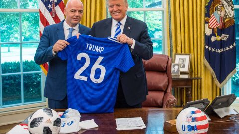 Donald Trump holds up a World Cup jersey. IMAGO