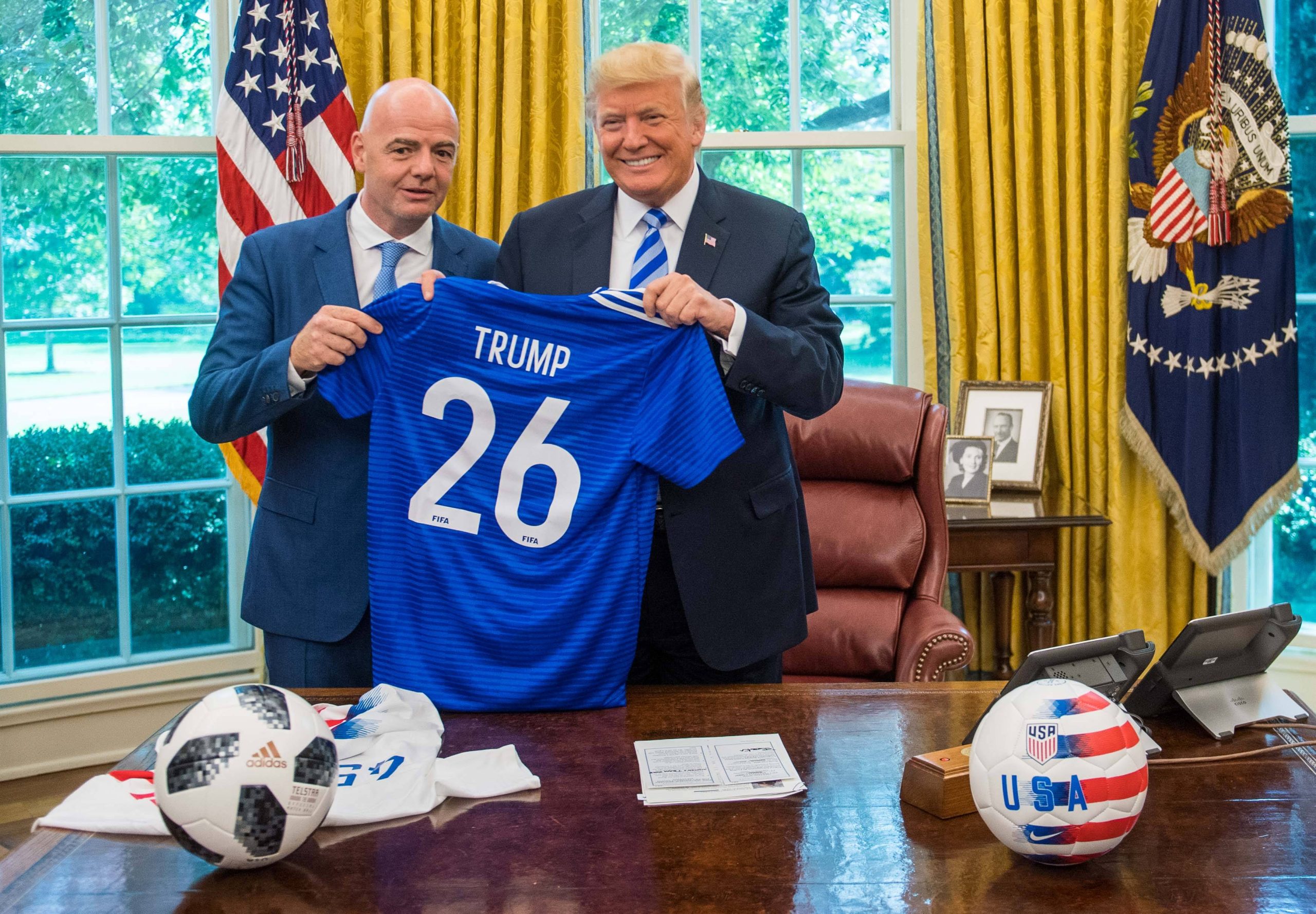 Donald Trump holds up a World Cup jersey. IMAGO